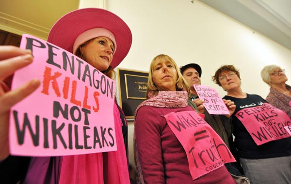 WikiLeaks supporters display placards and banners outside a room at the Rayburn House Office Building where a full committee hearing on the "Espionage Act and the Legal and Constitutional Issues Raised by WikiLeaks". (AFP)