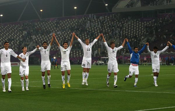 Members of Uzbekistan's national soccer squad celebrate after winning their game against Qatar's national soccer team after their AFC Asian Cup group A soccer match at Khalifa Stadium, in Doha, Qata. (AFP)