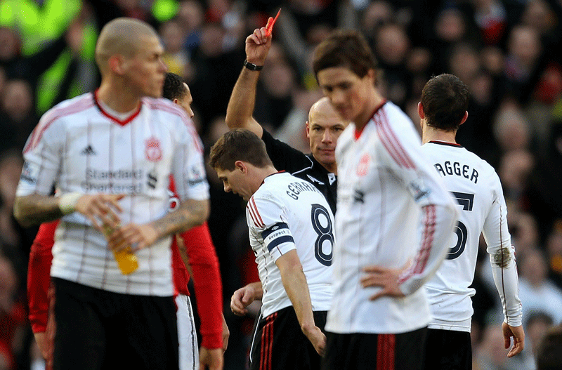 Referee Howard Webb shows Steven Gerrard of Liverpool a red card following his challenge on Michael Carrick of Manchester United during the FA Cup third round match at Old Trafford on Sunday. (GETTY)