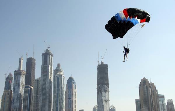 A member of the Armee Francaise team is pictured in front of Dubai's skyscrapers during the Gulf emirate's 2nd International Parachuting Championship and Gulf Cup 2011. (AFP)