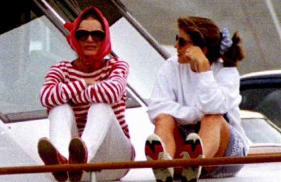 Jacqueline Kennedy Onassis sits with her daughter Caroline Schlossberg on the side of a yacht off Massachusetts in a file photo. (REUTERS)