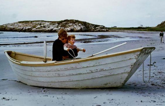 President John F. Kennedy hugs his son John F. Kennedy Jr. as they sit in a rowboat on the beach in Newport, Rhode Island, September 12, 1963. (REUTERS)