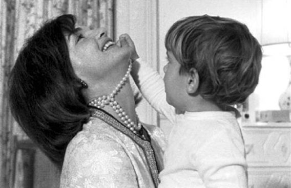 John Kennedy Jr. plays with his mother Jacqueline Kennedy's string of false pearls in August 1962. (REUTERS)