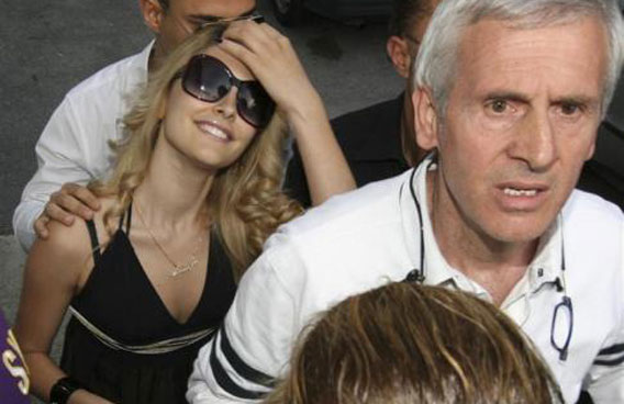 Aspiring model Noemi Letizia arrives at a polling station escorted by a police officer (R) to vote in European Parliament elections in Naples. (REUTERS)