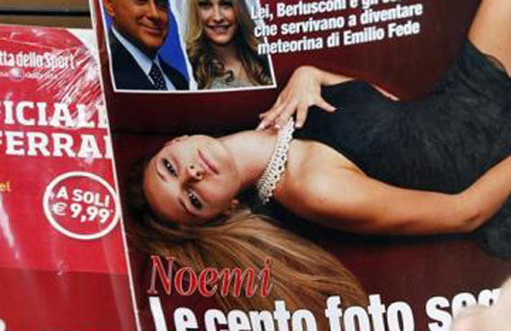 A man flips through an Italian magazine displaying on the cover exclusive pictures of aspiring model Noemi Letizia in central Rome Berlusconi was photographed at the 18th-birthday party of aspiring model Noemi Letizia. Soon after, his wife Veronica announced that she wanted a divorce, saying she could "no longer stay with a man who frequents minors". (REUTERS)