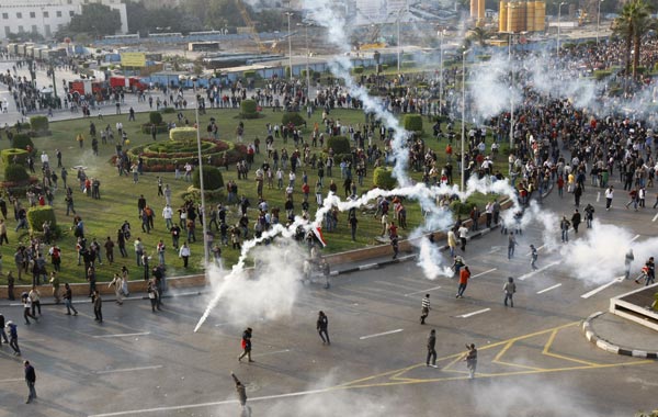 Tear gas smoke fired by Egyptian police is seen as demonstrators gather in central Cairo to demand the ouster of President Hosni Mubarak and calling for reforms. (AFP)