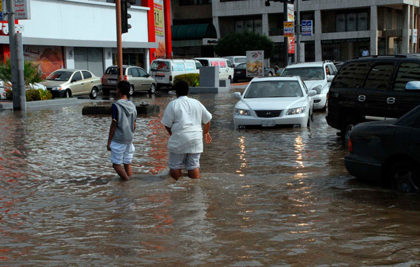 Men walk along a flooded street after heavy rainfall in Jeddah. Torrential rainfall submerged streets and cut off electricity in parts of Saudi Arabia's second largest city Jeddah on Wednesday, raising fears of a repeat of floods in 2009 which killed more than 120 people. (REUTERS)