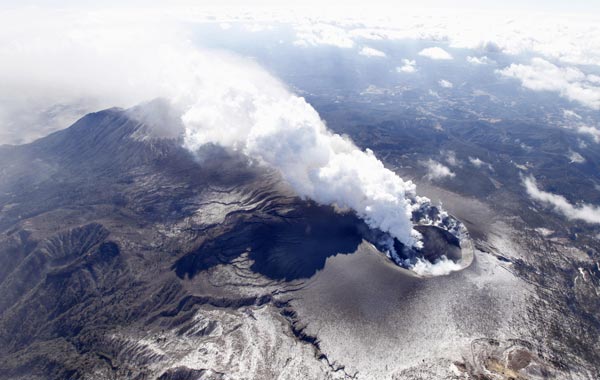 A dome of lava grow larger inside the crater as volcanic ash billows from Mount Shinmoedake in the Kirishimna range on Japan's southernmost main island of Kyushu. (AP)