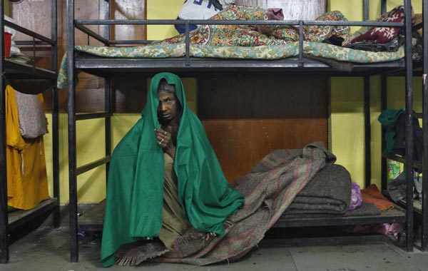 A homeless woman rests inside a shelter for homeless women and children managed by a non-governmental organisation (NGO) in New Delhi December 28, 2010. An intense spell of cold weather has forced hundreds of homeless to seek refugee in the shelters. Temperatures have dipped to 3.7 Celsius degrees (38.66 Fahrenheit) and reports say at least two people in the capital have died so far this winter. (REUTERS)
