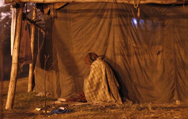 A homeless man sleeps outside a fully-occupied night shelter managed by an non-governmental organisation (NGO) in the old quarters of Delhi January 3, 2011. An intense spell of cold weather has forced hundreds of homeless to seek refugee in the shelters. Temperatures have dipped to 3.7 Celsius degrees (38.66 Fahrenheit) and reports say at least two people in the capital have died so far this winter. (REUTERS)