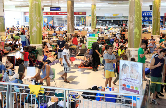People pack the food court at a shopping mall used as a evacuation shelter in Cairns, Australia, Wednesday, Feb. 2, 2011, as a monster cyclone approaches the northeast coast with furious winds, rains and surging seas on a scale unseen in generations. Gusts up to 186 mph (300 kph) were expected when Cyclone Yasi strikes the coast late Wednesday after whipping across Australia's Great Barrier Reef. (AP)