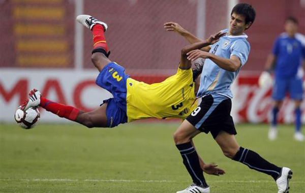 Ecuador's John Narvaez (L) trips while battling Uruguay's Federico Rodriguez during their Conmebol U-20 championship soccer match in Arequipa. (REUTERS)