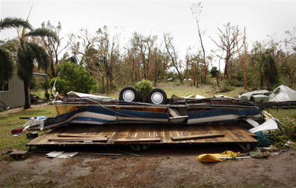 An overturned caravan lies flattened on the ground after Cyclone Yasi passed, in the northern Australian town of Cowley Beach. (REUTERS)