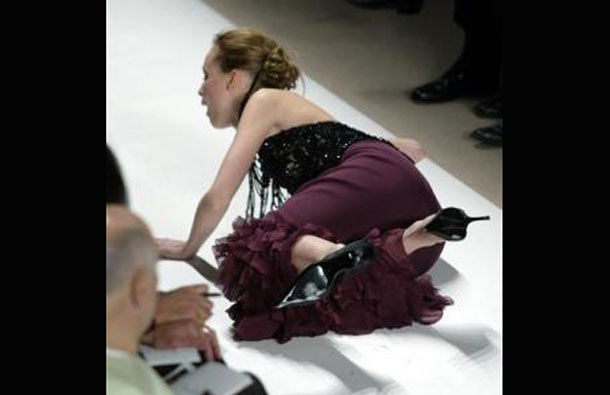 A model for designer Oscar de la Renta takes a tumble onto the runway during the presentation of the Oscar de la Renta Fall/Winter Collection in New York. (REUTERS)