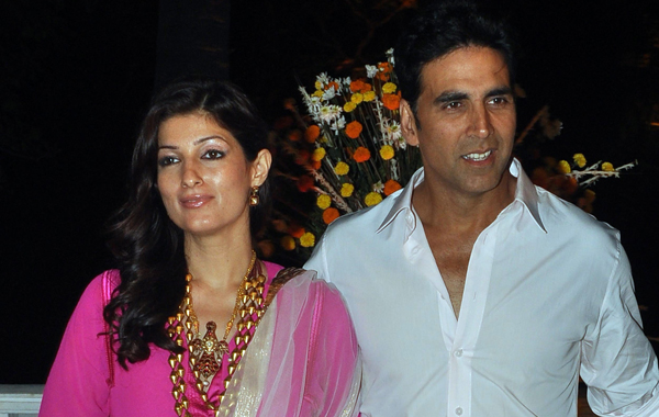 Indian Bollywood celebrities Akshay Kumar (R) with wife Twinkle Khanna (L) pose as they attend the wedding reception of Imran Khan and Avantika Malik in Mumbai. (AFP)