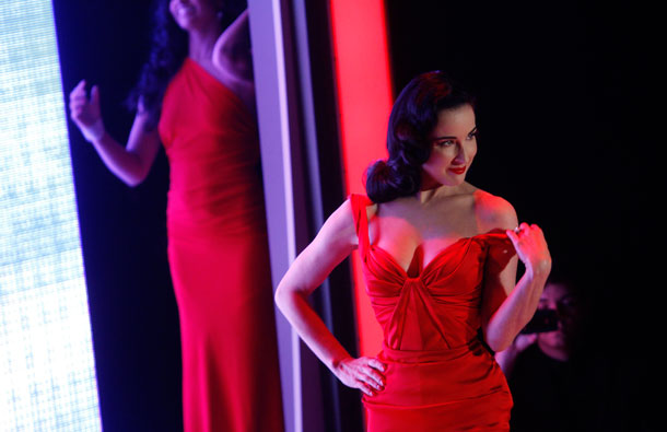 Burlesque artist Dita Von Teese presents a creation from Zac Posen during the Heart Truth's Red Dress Collection 2011 Fashion Show at New York Fashion Week. (REUTERS)