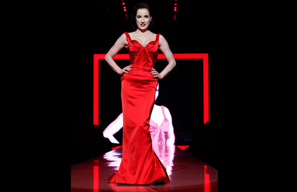 Burlesque model Dita Von Teese presents a creation by Zac Posen during the Heart Truth's Red Dress Collection 2011 Fashion Show at New York Fashion Week. (REUTERS)