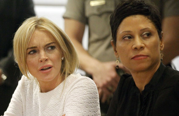 Lindsay Lohan (L) sits beside with her lawyer Shawn Chapman Holley during her arraignment after being charged with one count of felony grand theft for allegedly stealing a $2,500 necklace from a Venice Beach jewelry store, at the Airport Superior Court. The actress, who is on probation after completing a court-ordered spell in rehab for drug addiction, admits she took the necklace from a Venice Beach store but claims it was only on loan. (AFP)