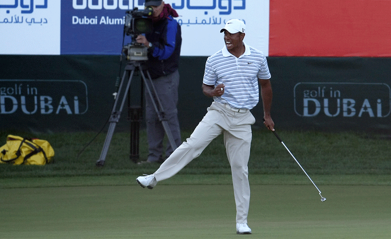 Tiger Woods dances after hitting a birdie on the 18th in the third round of the Dubai Desert Classic at Emirates Golf Club's Majlis course on Saturday. (DENNIS B. MALLARI)