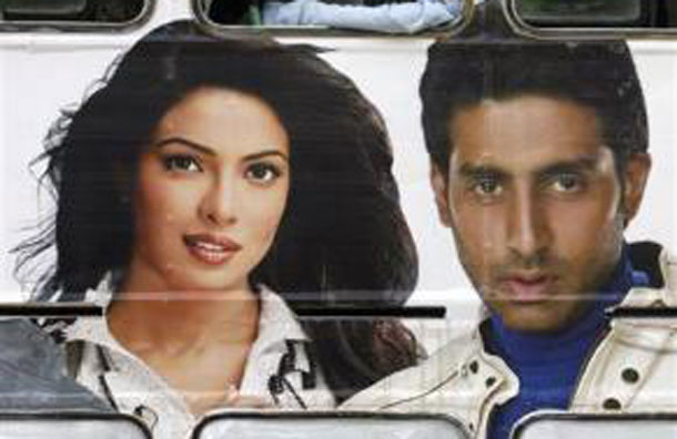 Commuters travel in a public bus displaying an advertisement with pictures of Bollywood actors Priyanka Chopra and Abhishek Bachchan in Mumbai April 28, 2008. (REUTERS)
