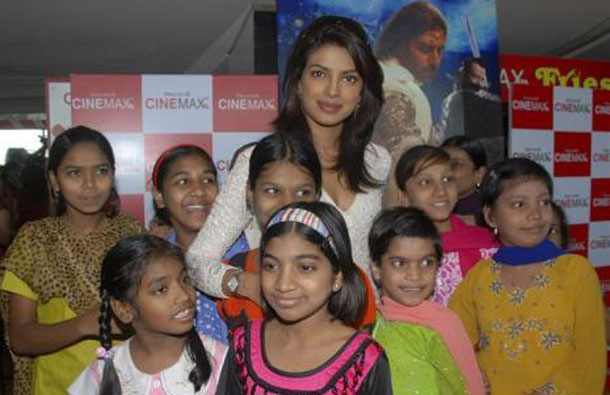 Bollywood actor Priyanka Chopra poses with underprivileged children during a special screening of her movie "Drona" in Mumbai October 2, 2008. (REUTERS)