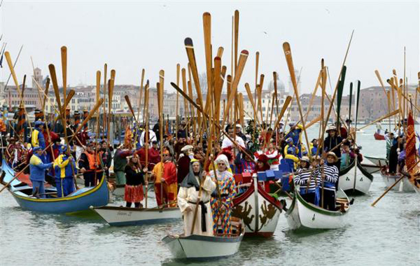 Venetians hold paddles during the masquerade parade on the Grand Canal during the first day of the carnival in Venice, February 20, 2011. (REUTERS)
