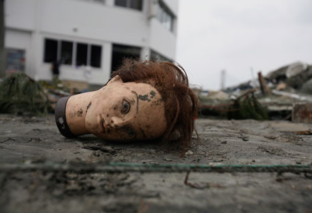A mannequin head lies in the tsunami debris Tuesday, March 15, 2011, in Soma city, Fukushima prefecture, Japan, four days after a massive earthquake and tsunami struck the country's north east coast. (AP