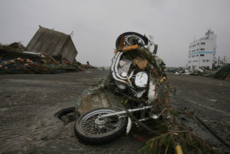 A Harley Davidson motorcycle sits on end in the destroyed waterfront Tuesday, March 15, 2011, in Soma city, Fukushima prefecture, Japan, four days after a massive earthquake and tsunami struck the country's north east coast. (AP)