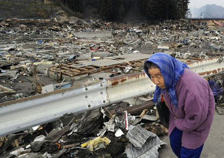 A woman returns after she visited an devastated area in Otsuchi, Iwate, northern Japan Tuesday, March 15, 2011 following Friday's massive earthquake and the ensuing tsunami. (AP