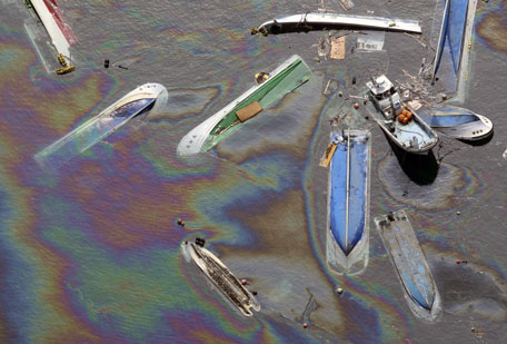 Vessels float on oil spilled water in Fudai, Iwate, northern Japan Monday, March 14, 2011 following Friday's massive earthquake and the ensuing tsunami. (AP)