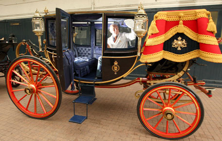 Carriage restorer, Dave Evans, cleans the windows in the Glass Coach at the Royal Mews in central London, Monday March 21, 2011. The coach, which was built in 1881, and is traditionally used by Royal brides to travel on their wedding day, will be used to carry Prince William and Kate Middleton in the event of bad weather on their wedding day on Friday, April 29, 2011. Should the weather be good on the day then the 1902 State Landau carriage will be used instead. (AP)