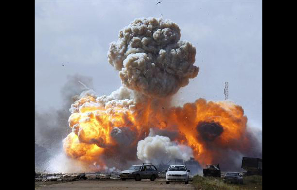 Vehicles belonging to forces loyal to Libyan leader Muammar Gaddafi explode after an air strike by coalition forces, along a road between Benghazi and Ajdabiyah. (REUTERS)