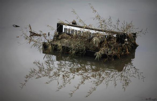 A piano is submerged in water in the area devastated by tsunami in Rikuzentakat. (REUTERS)