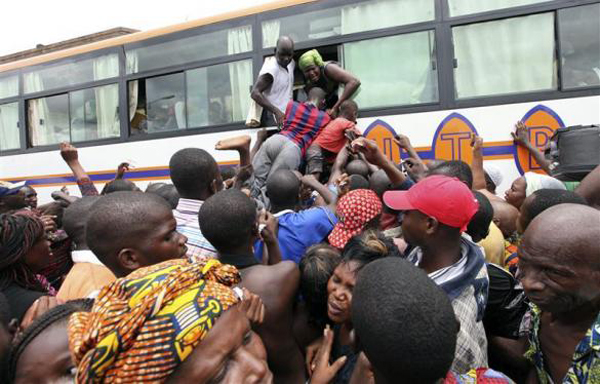 Residents try to get into a bus at the bus station of Adjame in Abidjan. Thousands of Ivorians fleeing violence in the commercial capital Abidjan gathered in its main bus station, crowding onto buses carrying suitcases full of belongings they had salvaged to head to the countryside. (REUTERS)
