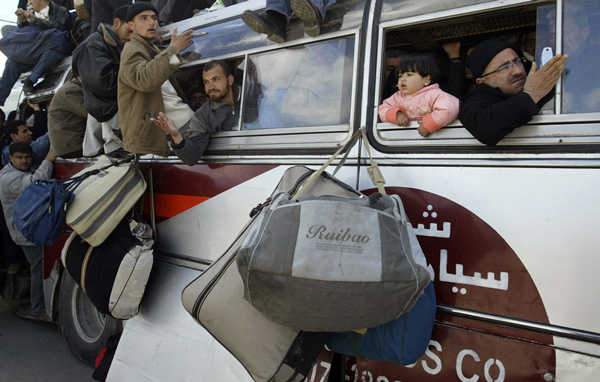 Palestinians wait inside a bus to pass through the Rafah border crossing, after it was reopened in the southern Gaza Strip March 6, 2007. The Rafah crossing, the Palestinians' only window to the outside world, has been closed most of the time since Palestinian militants abducted an Israeli soldier on June 25 in a cross-border attack inside an Israeli army base near Gaza. (REUTERS)