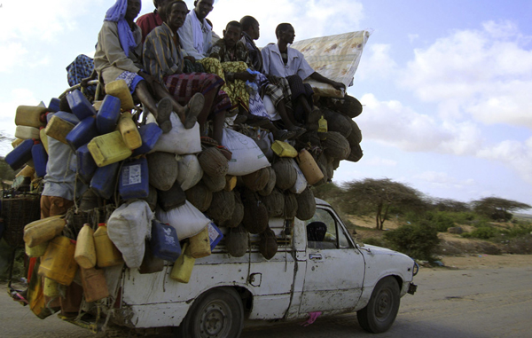 Residents ride on a pick-up truck that supplies milk and other items in Somalia's capital Mogadishu, September 2, 2009. (REUTERS)
