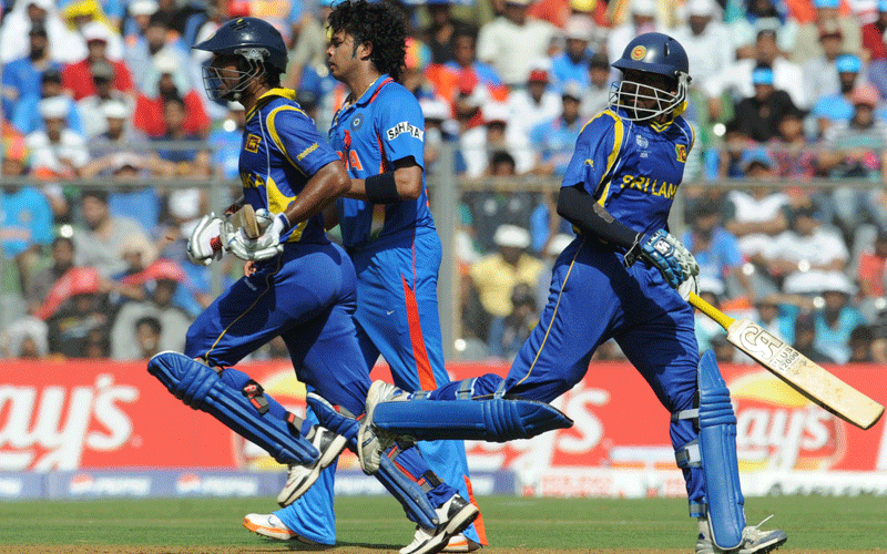 India bowler Shanthakumaran Sreesanth (C) watches as Sri Lanka batsman Kumar Sangakkara (L) and Tillakaratne Dilshan run between the wickets during the final match of the ICC Cricket world Cup 2011 between India and Sri Lanka at The Wankhede Stadium in Mumbai on April 2, 2011. Sri Lanka won the toss and elected to bat first. (AFP)