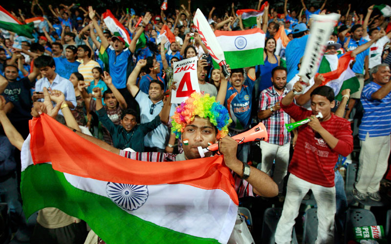 Fans of India cheer and hold up national flag as Indian won the ICC Cricket World Cup final match against Sri Lanka in Mumbai April 2, 2011 (REUTERS)