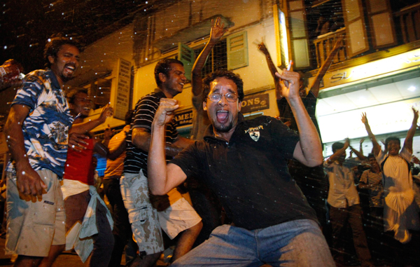 Cricket fans gets splashed with beer while celebrating that India won the ICC Cricket World Cup final match against Sri Lanka, in Singapore. (REUTERS)