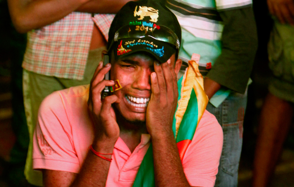 A Sri Lankan cricket fan speaks on the phone and cries after his team lost the World Cup Cricket finals to India, in Colombo, Sri Lanka. (AP)