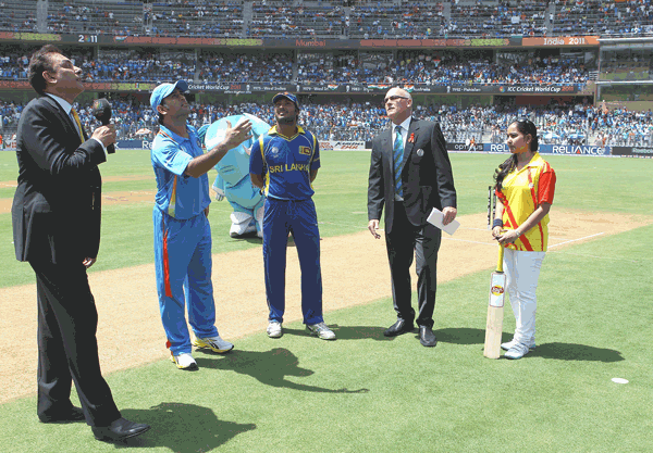 MS Dhoni of India tosses the coin for the first time with Kumar Sangakkara of Sri Lanka looking on during the ICC World Cup final at Wankhede Stadium on Saturday in Mumbai, India. (GETTY)