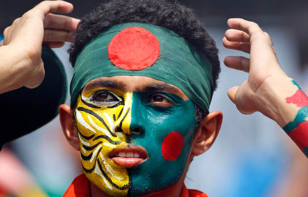A Bangladeshi fan with Bangladesh's national flag and and tiger painted on his face, looks on during their Cricket World Cup match against Ireland, in Dhaka, Bangladesh. The Royal Bengal Tiger is the national animal of Bangladesh. (AP)