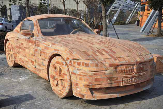 The car that is like a brick in strength...it's made of them.Chinese artist Dai Geng designed a model of a BMW Z4 sports car made from bricks. Dai spent more than a year cementing the brick blocks together and then carved it into a BMW Z4 model. The car weighs 6.5 tons. (AP)
