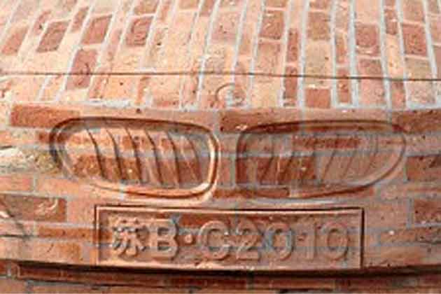 Dai Geng is asking for at least 80,000 pounds for the brick BMW car. (AP)