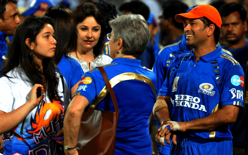 Mumbai Indians team captain Sachin Tendulkar (R) talks to his wife Anjali (2L) and his daughter Sara (L) after winning the cricket match against Deccan Chargers during the IPL Twenty20 match against Deccan Chargers  at the Rajiv Gandhi International Stadium in Hyderabad. Mumbai Indian won by 37 runs. (AFP)