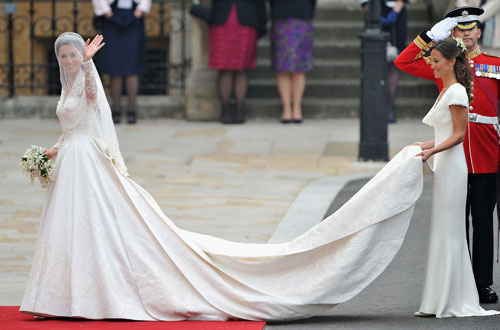 Catherine Middleton waves to the crowds as she arrives with her father Michael Middleton to attend the Royal Wedding of Prince William to Catherine Middleton at Westminster Abbey on April 29, 2011 in London. Kate Middleton's ivory and lace wedding dress was designed by Sarah Burton, creative director at the fashion house Alexander McQueen, the palace announced Friday (Getty Images)
