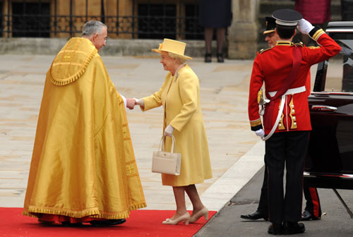 Britain's Queen Elizabeth II shakes hands with the Dean of Westminster as she arrives at the West Door of Westminster Abbey in London for the wedding of Britain's Prince William and Kate Middleton, on April 29, 2011 (AFP)