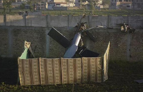 Part of a damaged helicopter is seen lying near the compound where al-Qaeda leader Osama bin Laden was killed in Abbottabad, May 2, 2011. (REUTERS)