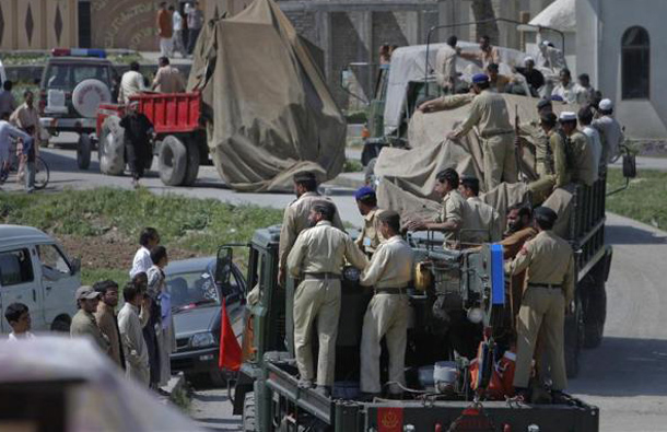 Pakistani soldiers remove the wreckage of a helicopter covered with it tarpaulin from a compound, where locals reported a firefight took place overnight in Abbotabad, located in Pakistan's Khyber Pakhtunkhwa province, May 2, 2011. (REUTERS)