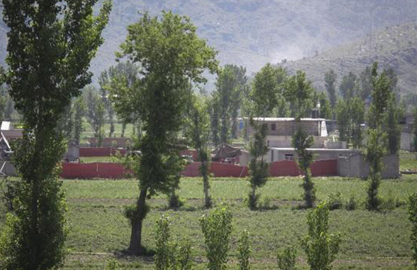 Surrounded in red fabric, a compound is seen where locals reported a firefight took place overnight in Abbotabad, located in Pakistan's Khyber Pakhtunkhwa province, May 2, 2011. (REUTERS)